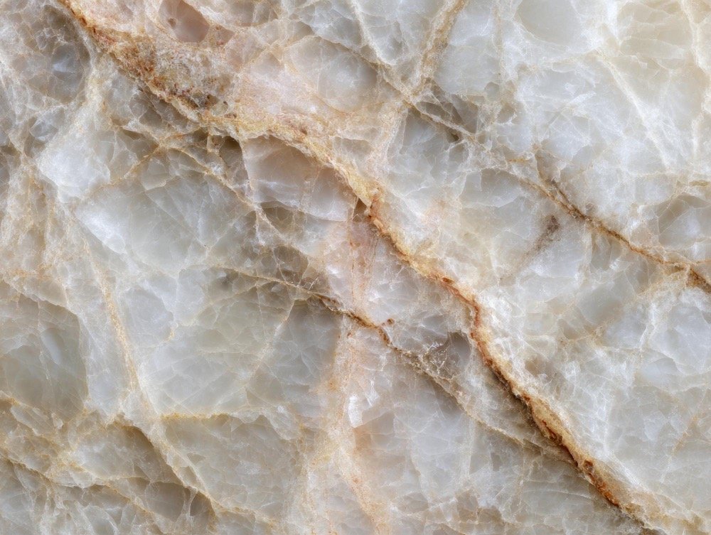 White quartzite slab with amber and gold veining