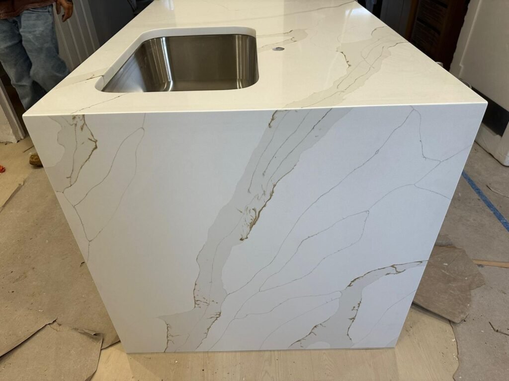 Calacatta gold quartz waterfall island — Quartz Solution, North Carolina