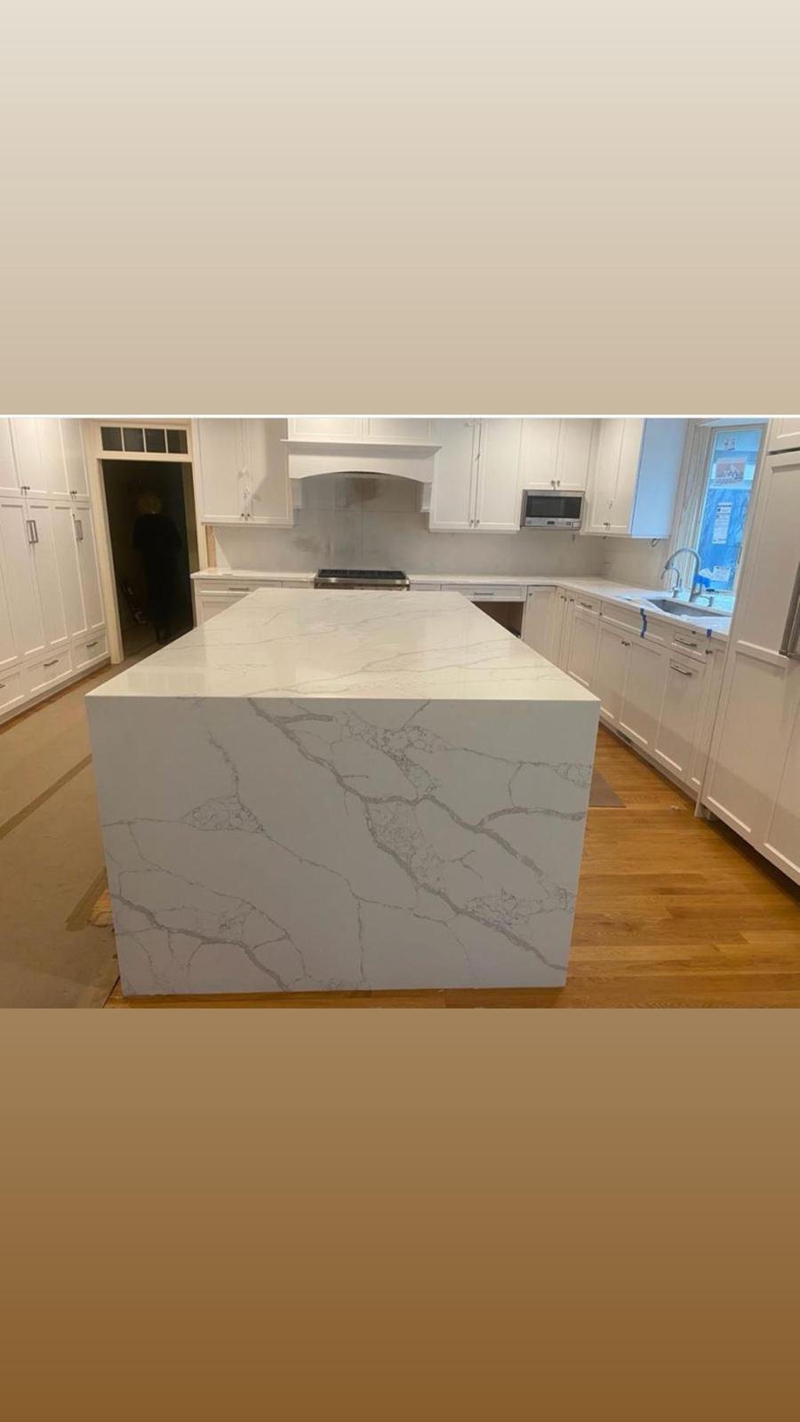 Calacatta quartz waterfall island — Quartz Solution, North Carolina