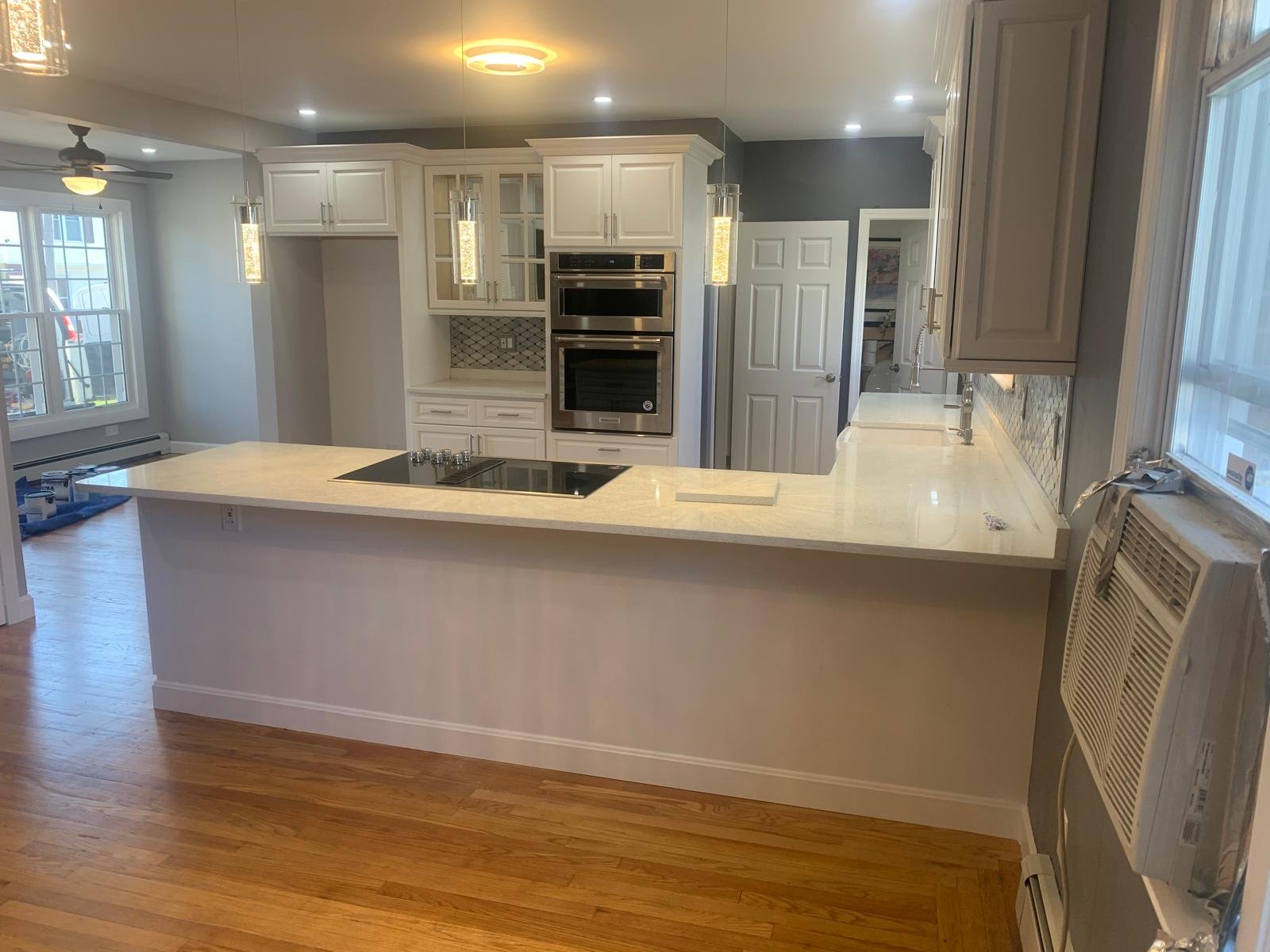 White quartz kitchen peninsula with a polished edge profile in a North Carolina home